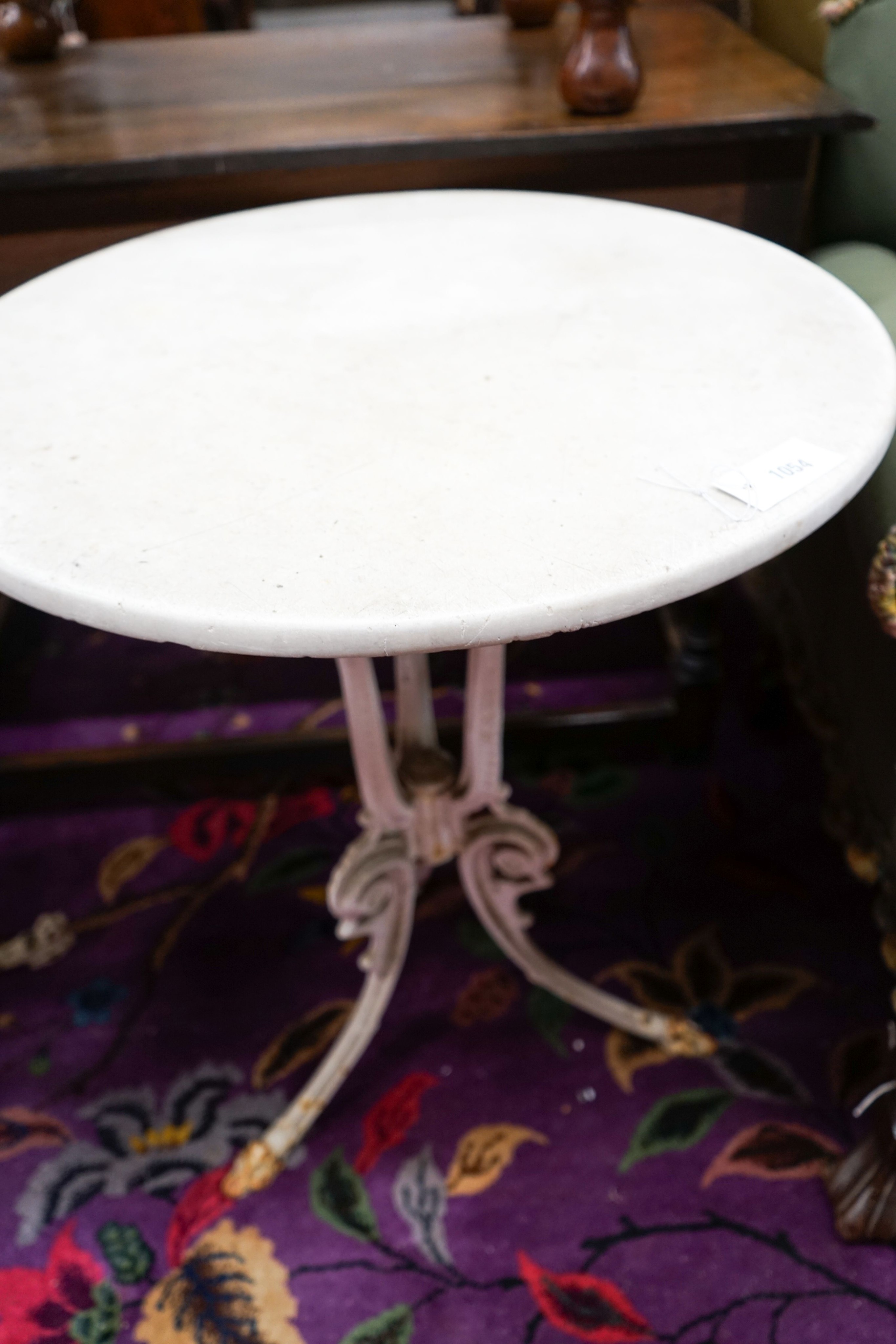 A near pair of painted cast iron circular marble top tables, larger 60cm diameter, height 71cm